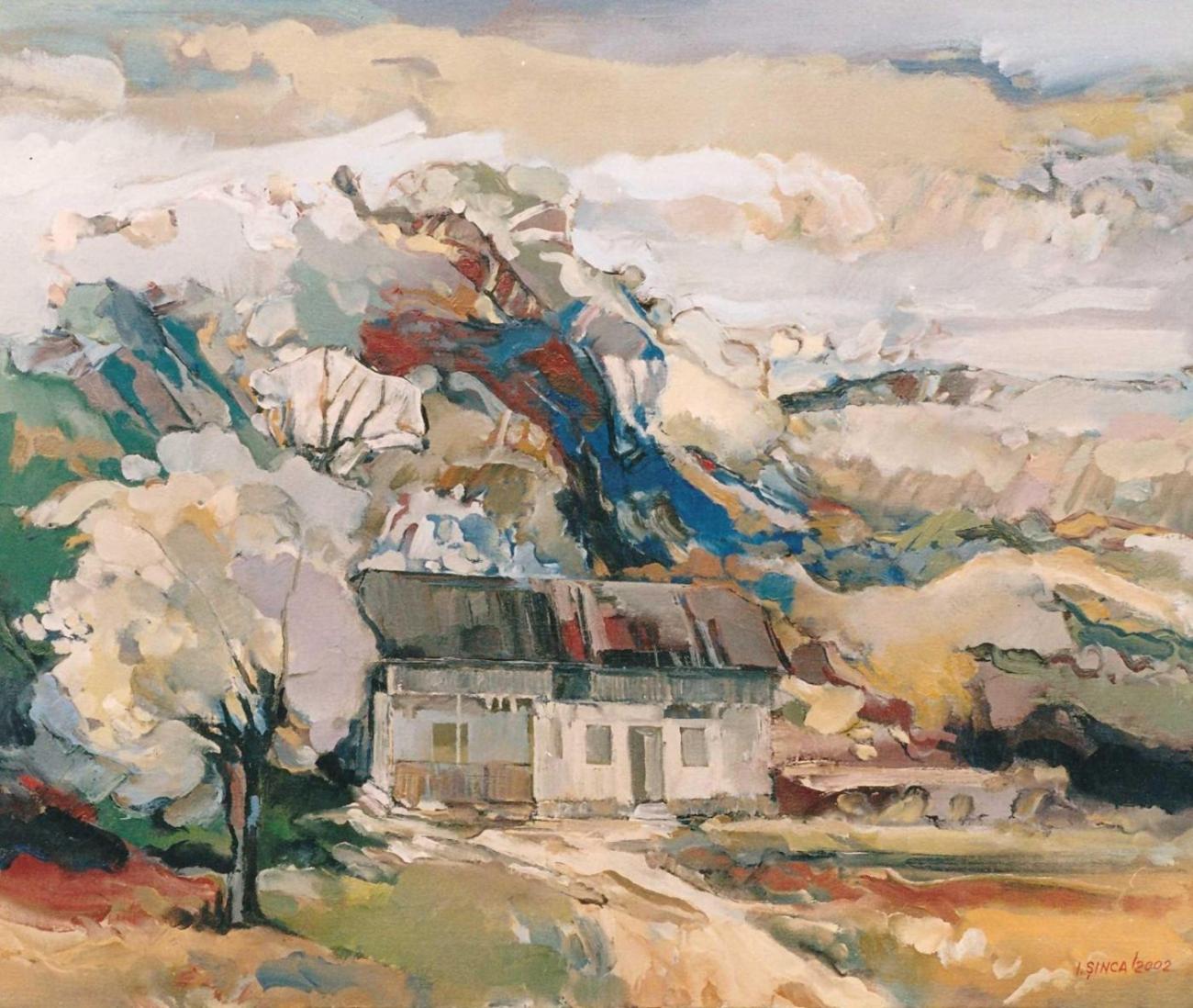 A house with a metal roof beneath a white blossoming tree, with a blue-white hill behind.